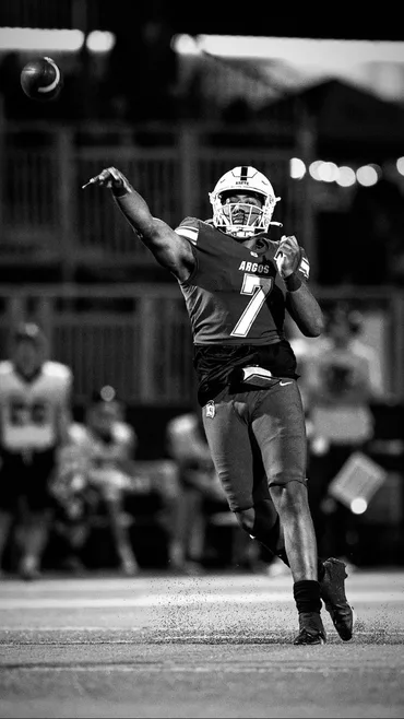 Quarterback releasing a throw in full pads
