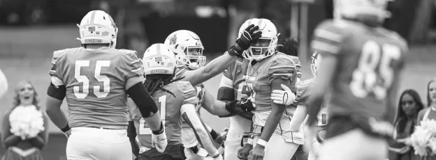 Football players celebrating together on the field