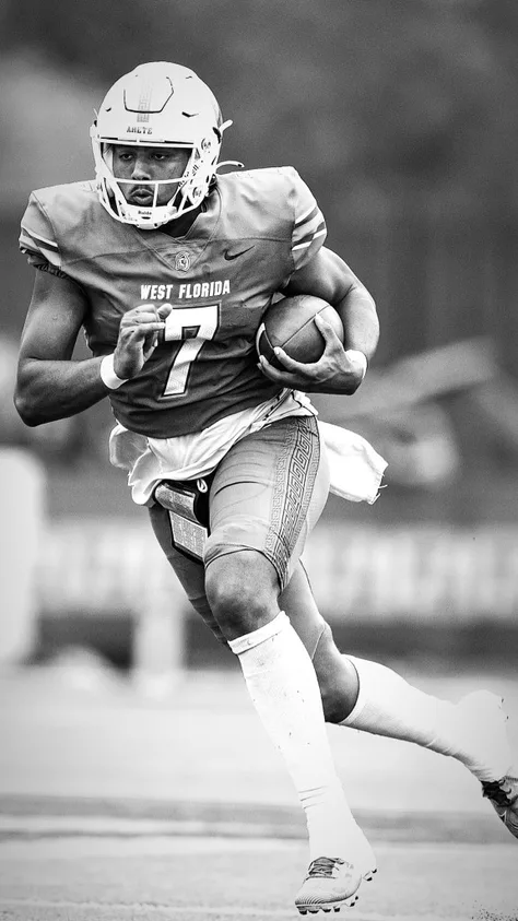 Football player in West Florida 7 jersey running with the ball